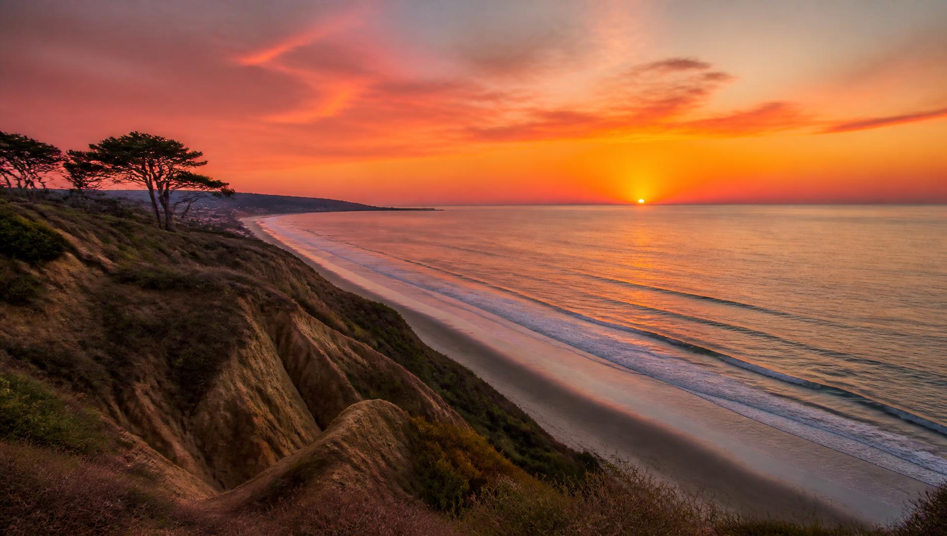 Clifftop view of a San Diego beach sunset above the Pacific