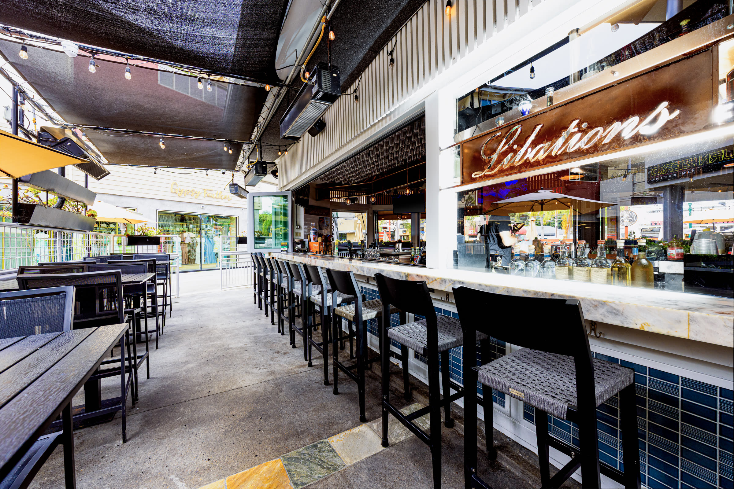 The libations bar at Bier Garden Encinitas with tap handles and bottles lit from behind