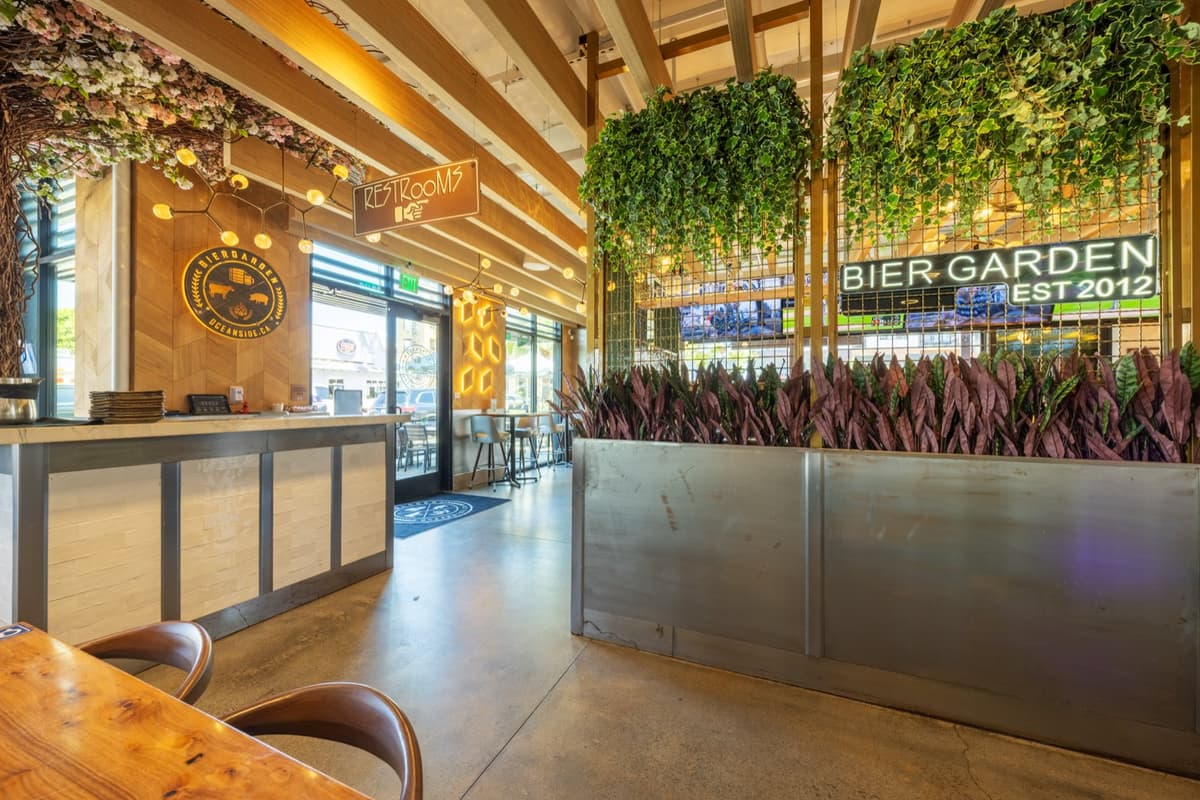 The host stand and living greenery wall with the Bier Garden Oceanside crest